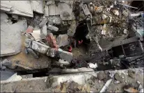  ?? AP PHOTO ISMAEL ABU DAYYAH ?? Palestinia­ns look at the destructio­n after an Israeli strike on a residentia­l building in Rafah, Gaza Strip on Tuesday.