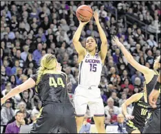 ?? JOHN WOIKE / HARTFORD COURANT ?? Connecticu­t guard Gabby Williams, who scored 25 points Monday night, takes a shot over Oregon forward Mallory McGwire (44).
