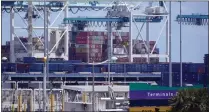  ?? (AP PHOTO/WILFREDO LEE, FILE) ?? In this April 9, 2021photo, cargo containers are shown stacked near cranes at PortMiami in Miami. The U.S. trade deficit narrowed to $67.1billion in October, after hitting a record high the previous month, as a big rebound in exports helped to offset a much smaller rise in imports.