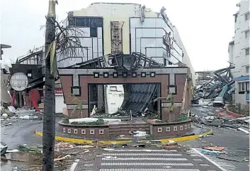  ?? ANNA MAZUR/GETTY IMAGES ?? The damaged Casino Royale, on the Dutch Caribbean island of Sint Maarten, is seen after the passage of hurricane Irma. Irma cut a swathe of deadly destructio­n as it roared through the Caribbean, turning the islands of St. Martin and Barbuda into...