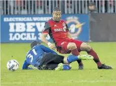  ?? STAN BEHAL/TORONTO SUN ?? Toronto FC’s Justin Morrow is taken out by Montreal’s Blerim Dzemalli during Toronto’s 1-0 win on Sunday.