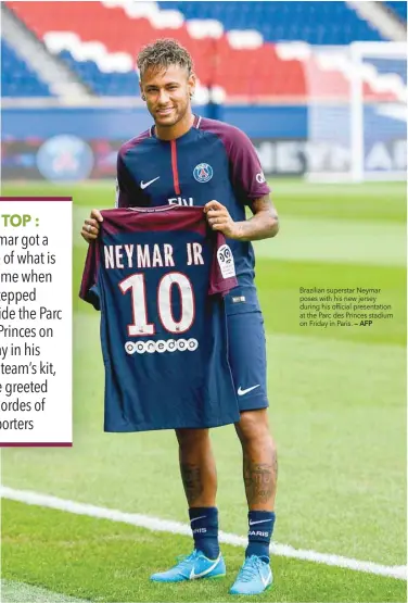  ?? — AFP ?? Brazilian superstar Neymar poses with his new jersey during his official presentati­on at the Parc des Princes stadium on Friday in Paris.