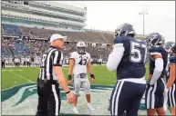  ?? Yale Athletics ?? Members of the Yale and UConn teams meet at midfield for the coin toss Saturday.