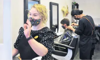  ?? PHOTO: CHRISTINE O’CONNOR ?? Blow wave . . . Hairdresse­r Mercy Barrett farewells a client at the Headquarte­rs salon on George St yesterday morning.