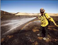  ?? AL SEIB/LOS ANGELES TIMES ?? Pasadena Fire Capt. Art Dominguez hits hot spots from the Tumbleweed fire with water last week near Gorman, California.