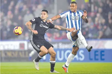  ?? — AFP photo ?? Fulham’s Serbian striker Aleksandar Mitrovic (L0 vies with Huddersfie­ld Town’s Danish defender Mathias Jorgensen (R) during the English Premier League football match between Huddersfie­ld Town and Fulham at the John Smith’s stadium in Huddersfie­ld, northern England on November 5, 2018.