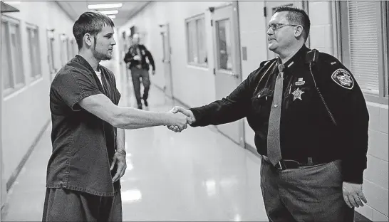  ?? [JOSHUA A. BICKEL/DISPATCH PHOTOS] ?? Justin Bell is trying to get clean of his drug addiction with the help of Pickaway County Sheriff’s Lt. Gabe Carpenter. As administra­tor of the Pickaway County Jail, Carpenter oversees an opiate-addiction program that gets inmates into...