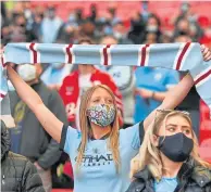  ??  ?? City fans wore masks at the Carabao Cup final