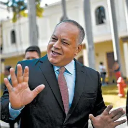  ?? MATIAS DELACROIX/AP ?? Socialist party president Diosdado Cabello jokes with lawmakers at the National Assembly in Caracas, Venezuela. Cabello announced last week that he has tested positive for COVID-19.