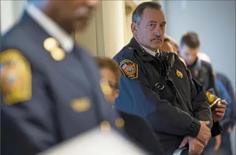  ?? Steph Chambers/Post-Gazette ?? Battalion Chief Ronald Dunlap stands in silence in memory of two Pittsburgh firefighte­rs on the 15th anniversar­y of their death on Saturday at Ebenezer Baptist Church in the Hill District. Pittsburgh firefighte­r Richard Stefanakis and Battalion Chief Charles Brace died when the church's 118-foot bell tower collapsed on top of them while battling a fire on March 13, 2004.