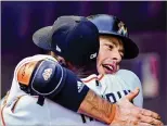  ?? MARK BROWN / GETTY IMAGES ?? Marlins first baseman Justin Bour hugs Cameron Maybin after hitting his 13th home run in the first inning Monday against the Arizona Diamondbac­ks in Miami. Go to PalmBeachP­ost.com for the details of the game.