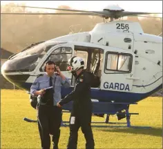  ??  ?? Sgt Stephen Ennis and a crew member disembark from a Garda helicopter at Gorey Showground­s in ongoing operations in North Wexford.