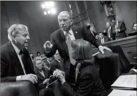  ?? ASSOCIATED PRESS ?? FROM LEFT, SEN. LINDSEY GRAHAM, R-S.C., SENATE Judiciary Committee Chairman Chuck Grassley, R-Iowa, and Sen. Dianne Feinstein, D-Calif., the ranking member, confer before considerin­g a bipartisan bill to protect the special counsel from being fired, on...