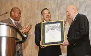  ??  ?? Mayor Sylvester Turner, from left, and William Harris, CEO of Space Center Houston, honor Kranz. Restoratio­n of Historic Mission Control is his goal.