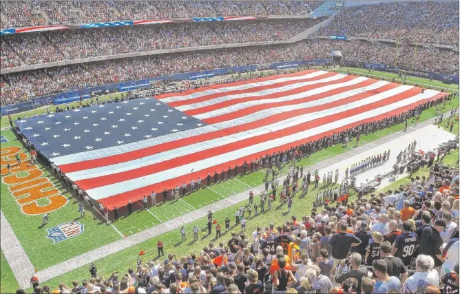  ?? | TOM CRUZE~SUN-TIMES ?? A 100-yard-long American flag was presented during the national anthem at the Bears’ season opener last fall, on Sept. 11, 2011.