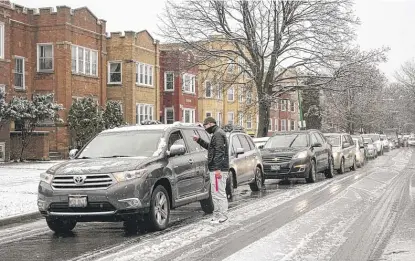  ?? PAT NABONG/SUN-TIMES ?? A line of people in cars stretches almost a block long outside Prism Health Lab’s drive-thru COVID-19 testing and vaccinatio­n site in the West Rogers Park neighborho­od on Tuesday.