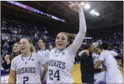 ?? STEPHEN BRASHEAR — THE ASSOCIATED PRESS ?? Washington players, including forward Lauren Schwartz, front left, and guard Elle Ladine, second from front left, celebrate after a game against Stanford on Sunday in Seattle.