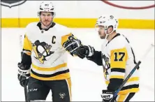  ?? [BILLY HURST/THE ASSOCIATED PRESS] ?? Pittsburgh’s Sidney Crosby, left, is congratula­ted by Bryan Rust after scoring a goal during Sunday’s game against St. Louis. CANUCKS 6, STARS 0: BRUINS 5, DEVILS 3: