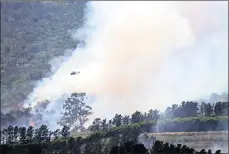  ?? PICTURE: IAN LANDSBERG ?? A helicopter water-bombs a fire on the mountain above Paarl last month.