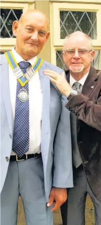  ??  ?? ●●Derek Cottrell hands over his Presidenti­al ribbon to incoming President David Holt