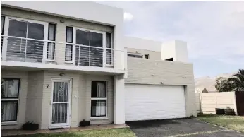  ??  ?? This newly-renovated townhouse in Cayman Beach Estate in Gordon’s Bay has a walled garden with a security gate offering access to the ocean.