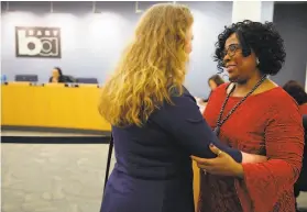  ?? Santiago Mejia / The Chronicle 2019 ?? Wanda Johnson (right), Oscar Grant’s mother, is embraced by Julie Wedge, chief of staff to Oakland City Councilwom­an Rebecca Kaplan, after a BART vote in February 2019. Grant was shot and killed by a BART police officer at Fruitvale Station in 2009.