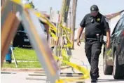  ?? STACEY WESCOTT/CHICAGO TRIBUNE ?? An officer walks near a barricade along the 3900 block of Center Avenue in Lyons, where authoritie­s believe bodies were uncovered Saturday.