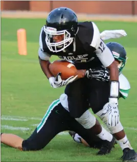  ?? Jeremy Stewart / Rome News-Tribune ?? Coosa’s Kenon Dixon (12) tries to pull away from Pickens County’s Ian Burdge during the first quarter of a preseason scrimmage Friday at Coosa’s Branch Bragg Field.