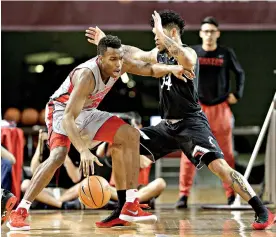  ?? AP Photo/Michael Wyke ?? ■ Houston forward Fabian White Jr. (35) looks for a way around Cincinnati guard Jarron Cumberland (34) during the first half of an NCAA game Thursday in Houston.