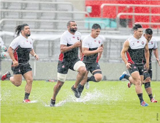  ??  ?? Japan players train in the rain yesterday as Typhoon Hagibis hits the country.