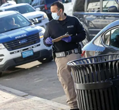  ?? MATT STONE / HERALD STAFF ?? ‘IT’S A BABY’: Police work at the scene in Dorchester Lower Mills where a newborn was found in a trash can on Dorchester Avenue.