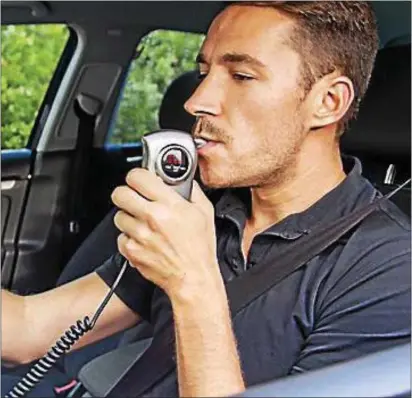  ??  ?? A driver is shown using an ignition interlock.