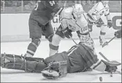  ?? Ross D. Franklin Associated Press ?? COYOTES goaltender Adin Hill makes a save on a shot by Kings center Tobias Rieder (10).