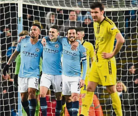  ??  ?? Experience matters: Manchester City’s Phil Foden (centre) celebratin­g with Gabriel Jesus (left) and David Silva after scoring during the League Cup semi-final first-leg match against Burton Albion at the Etihad on Wednesday. — AFP