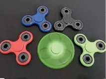  ??  ?? Fidget spinners are marketed as devices that ease anxiety and assist concentrat­ion, but retailers say they have fast become must-have acquisitio­ns in their own right.