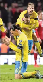  ??  ?? COPENHAGEN: Sweden’s forward and team captain Zlatan Ibrahimovi­c (R) celebrates with his teammates as they qualify to Euro 2016 in France after the Euro 2016 second leg play-off football match between Denmark and Sweden at Parken stadium in Copenhagen...