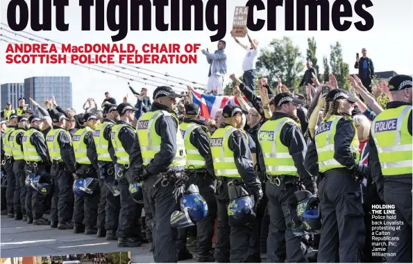  ??  ?? HOLDING THE LINE Police hold back Loyalists protesting at a Calton Republican­s march. Pic: Jamie Williamson