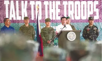  ?? / AP FOTO ?? GOVERNMENT TROOPS. President Rodrigo Duterte (third from right) addresses government troops during his visit in Jolo, Sulu province in Mindanao.