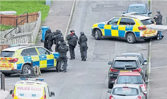  ?? Pictures: George Mcluskie. ?? One of two men arrested after officers ended the siege is taken away by armed police.