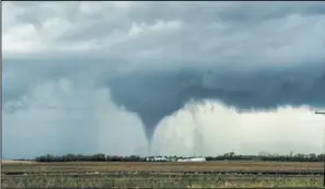  ??  ?? On May 24, 2019, severe thundersto­rms across eastern North Dakota produced tornadoes, funnels, hail, damaging winds and heavy rains. This tornado, captured by Carl Jones as it touched down near Leal, was part of that low pressure system.