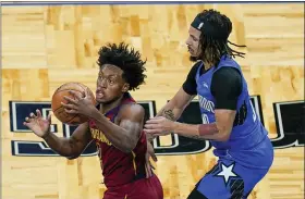  ?? JOHN RAOUX — THE ASSOCIATED PRESS ?? Collin Sexton prepares to pass as he is guarded by the Magic’s Cole Anthony on Jan. 6 in Orlando, Fla.