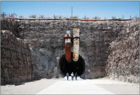  ?? JOHN LOCHER / ASSOCIATED PRESS ?? People leave the south portal of Yucca Mountain during a congressio­nal tour July 14.