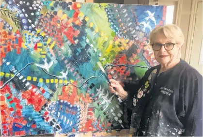  ?? CONTRIBUTE­D ?? Alice Dicks, 85, continues to work hard every day painting at her art studio in Grand Falls-Windsor. Recently, she has taken interest in abstract art. She is seen here with one of her abstract paintings in her studio.