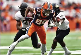  ?? ADRIAN KRAUS - THE ASSOCIATED PRESS ?? Syracuse wide receiver Taj Harris (80) eludes Wake Forest defensive back Zion Keith, left, and defensive back Ja’Sir Taylor after a catch during the first half of an NCAA college football game in Syracuse, N.Y., Saturday, Nov. 30, 2019.