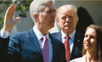  ?? EVAN VUCCI/AP 2017AP ?? Then-President Trump watches as Supreme Court Justice Neil Gorsuch, accompanie­d by wife Marie Louise, is sworn in.