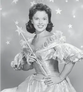  ?? Hulton Archive/TNS ?? American actor Shirley Temple wears a fairy godmother costume, which includes a magic wand and tiara, in a promotiona­l portrait for her television series of dramatized fairy tales, “Shirley Temple's Storybook,” in 1958.