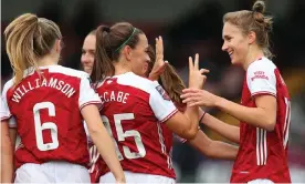  ??  ?? Vivianne Miedema celebrates with her Arsenal teammates after scoring her third and the team’s fifth against Spurs. Photograph: Catherine Ivill/Getty Images