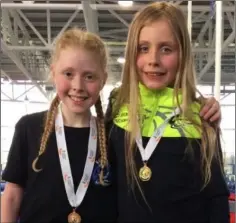  ??  ?? Grainne Moran (3rd U12 girls 600m) and Enya Silkena (1st U12 girls long jump, 4th shot putt) , Dundalk St Gerards AC at the All- Ireland Indoor Championsh­ips in Athlone.