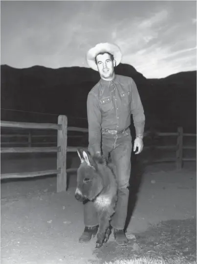  ?? PHOTOS PROVIDED BY THE PALM SPRINGS HISTORICAL SOCIETY ?? Frank Bogert and baby burro in Palm Springs.