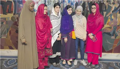  ?? ODD ANDERSEN / AFP / GETTY IMAGES ?? Nobel Peace Prize laureate Malala Yousafzai, in blue hijab, poses with five young activists, from left, Nigerian Amina Yusuf, Pakistani Kainat Somroo, schoolmate­s Shazia Ramzan and Kainat Riaz, and Syrian Mezon Almellehan.